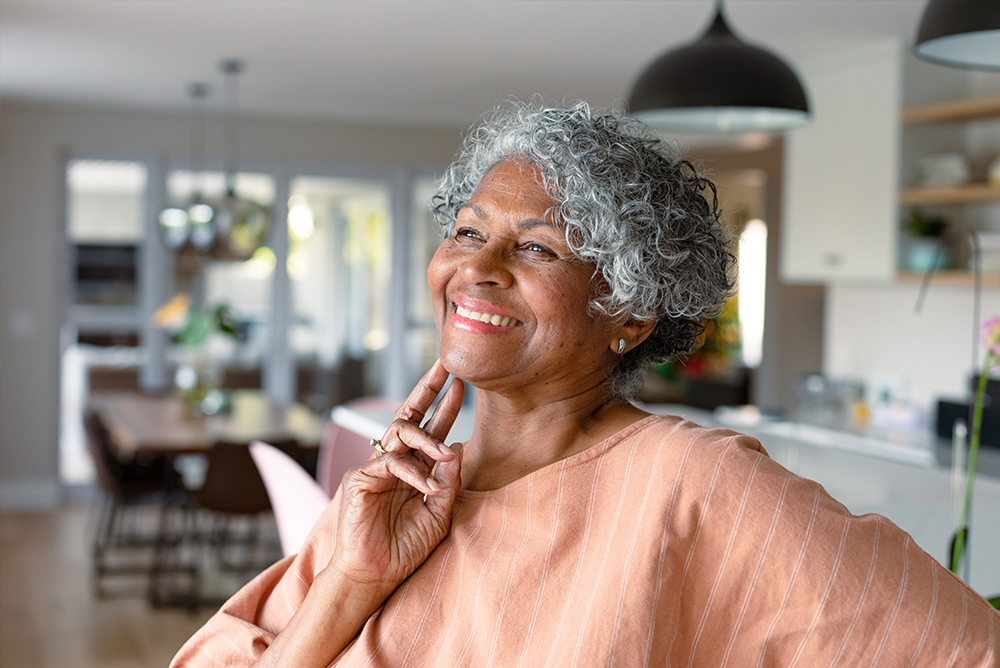 Middle aged African American woman in peach colored shirt