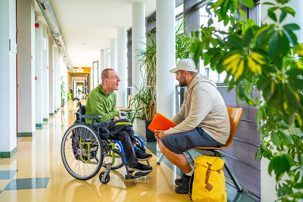 ALS patient in a wheelchair with a caretaker